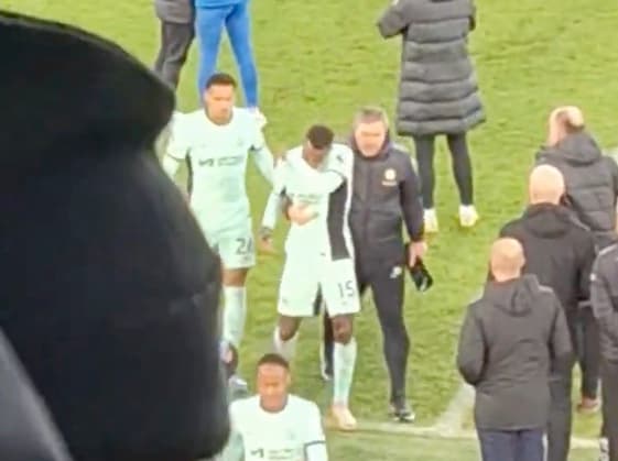 Nicolas Jackson pictured (center) being dragged off the field by a member of Chelsea's coaching staff following a 2-0 loss at Everton in December 2023